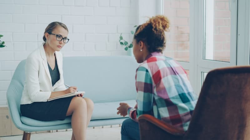 Licensed counselor in a therapy session with an educator