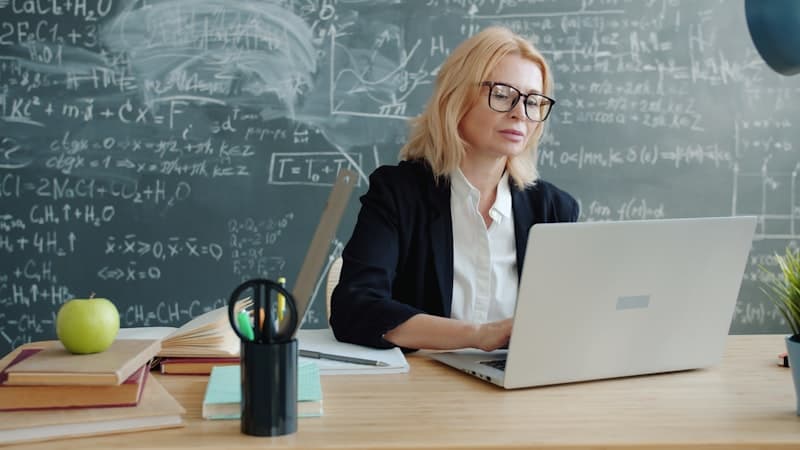 Educator working at her desk in a classroom